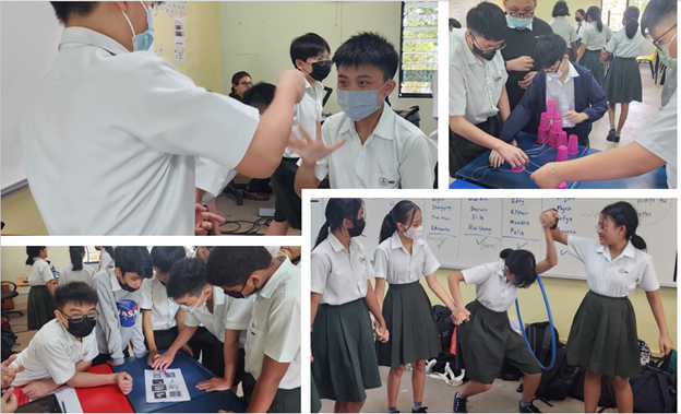 Students in school uniforms and masks engage in group activities in a classroom setting.